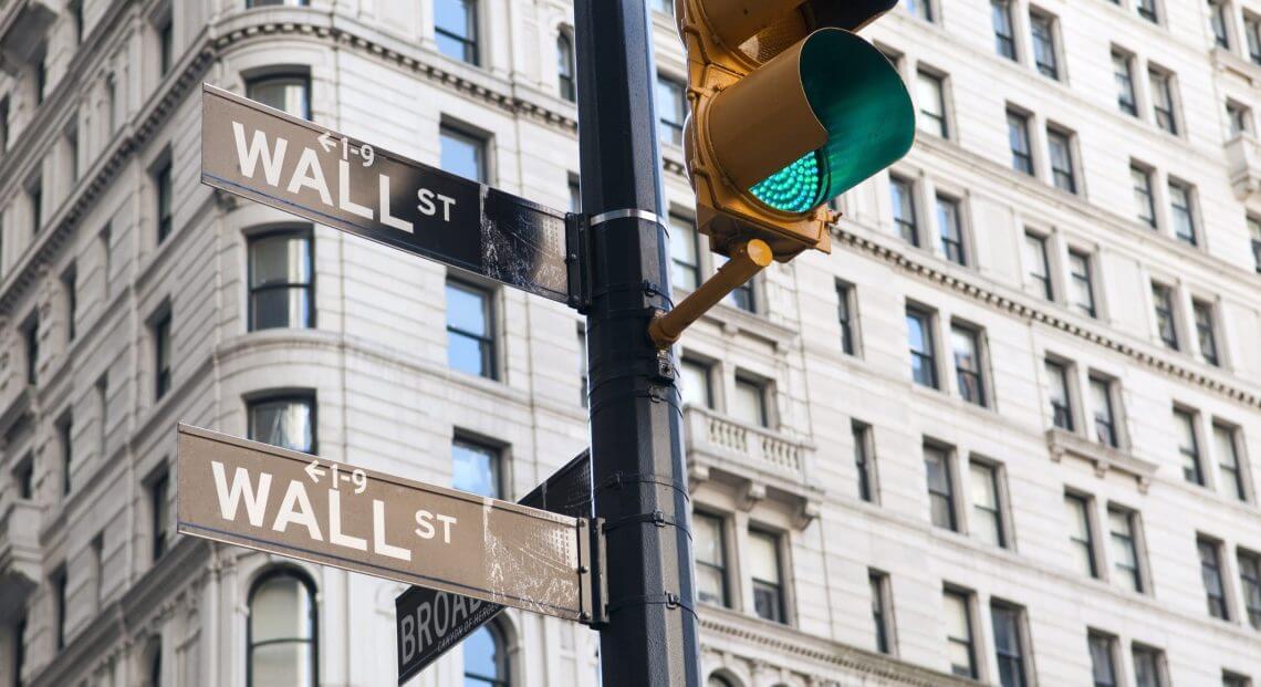 Wall Street sign with green light, symbolizing financial growth