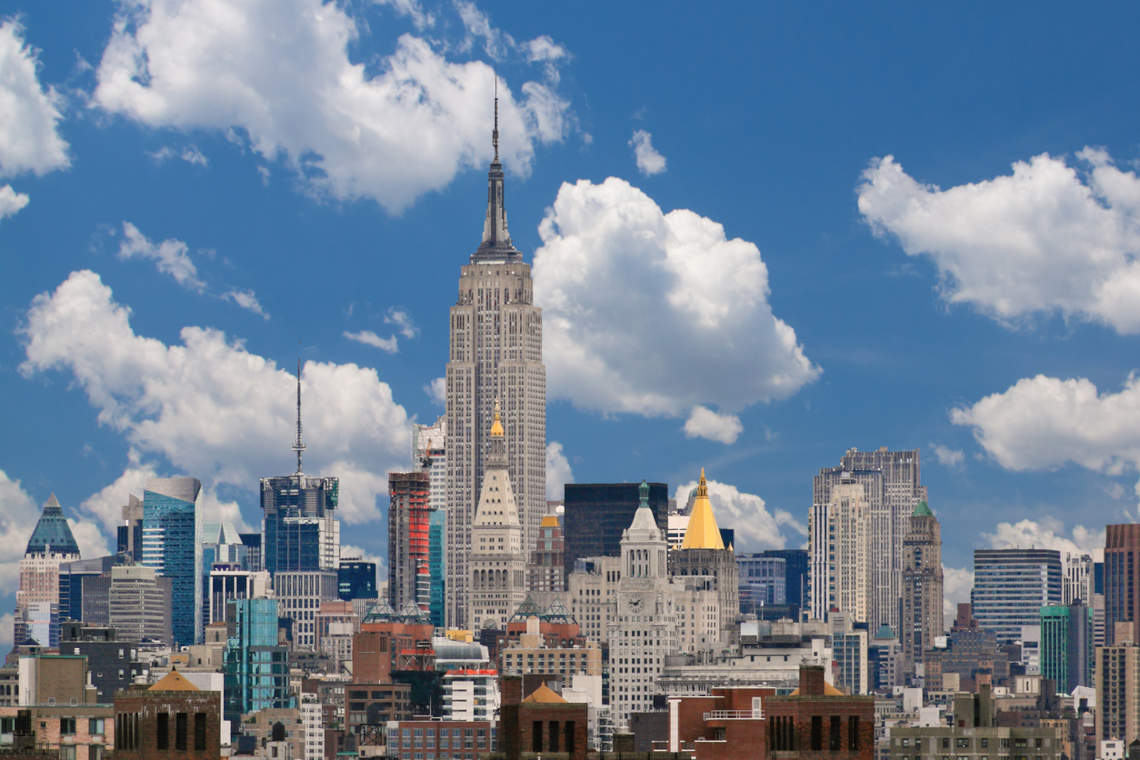 Manhattan skyline with Empire State Building, NYC, home to 10 of the greenest office buildings in the world.