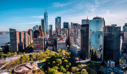 Golden hour aerial view of Downtown Manhattan, hotspot for NYC commercial real estate.