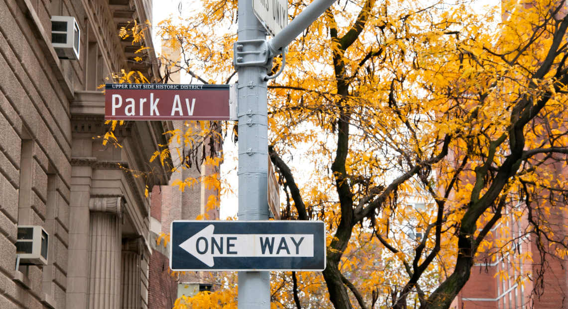 Park Avenue and One Way signs in NYC, prime financial services office search location.