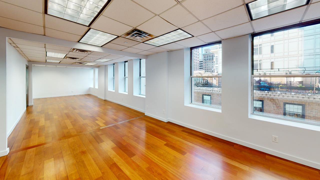 315 Fifth Avenue Office Space - open-space office setting with oversized windows facing East