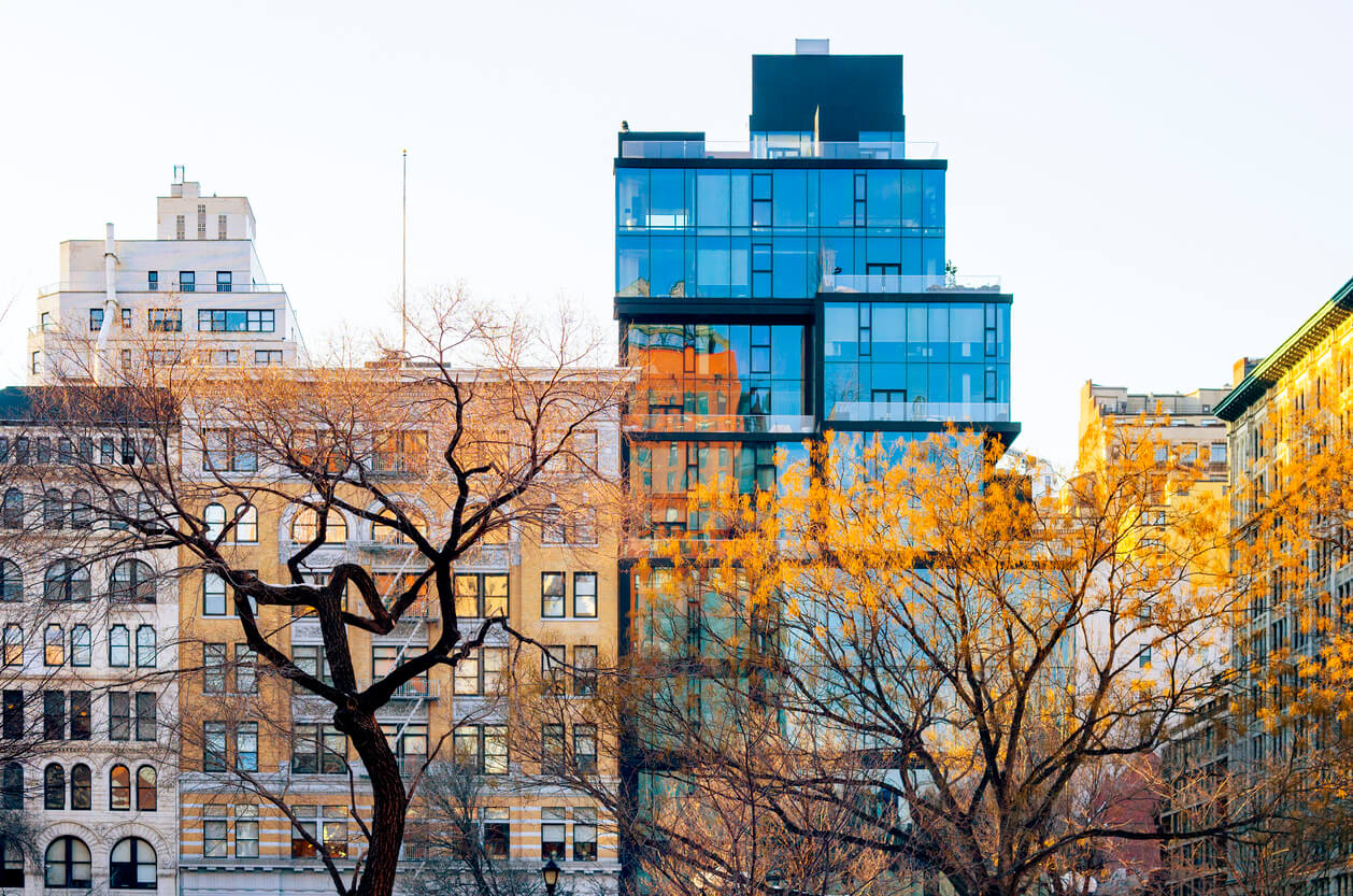 Sunset illuminates Union Square's buildings in NYC, a hub for architecture and design firms.