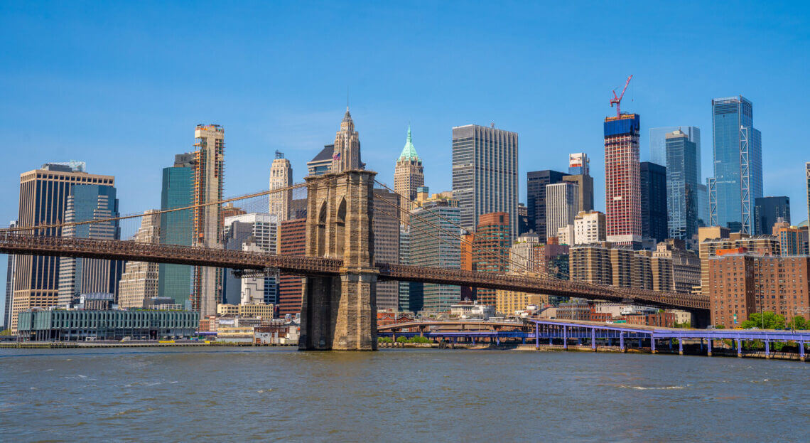 View of Brooklyn Bridge & Financial District's office towers in NYC.