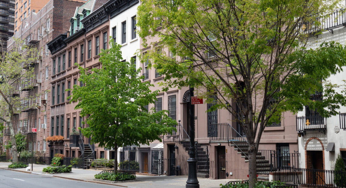 A row of beautiful townhouses along an empty street on the Upper East Side.