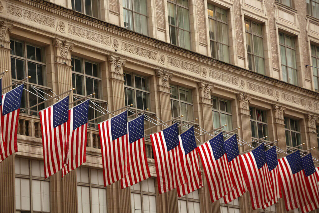 A row of American flags flying on Fifth Avenue in Midtown Manhattan, New York City, USA.