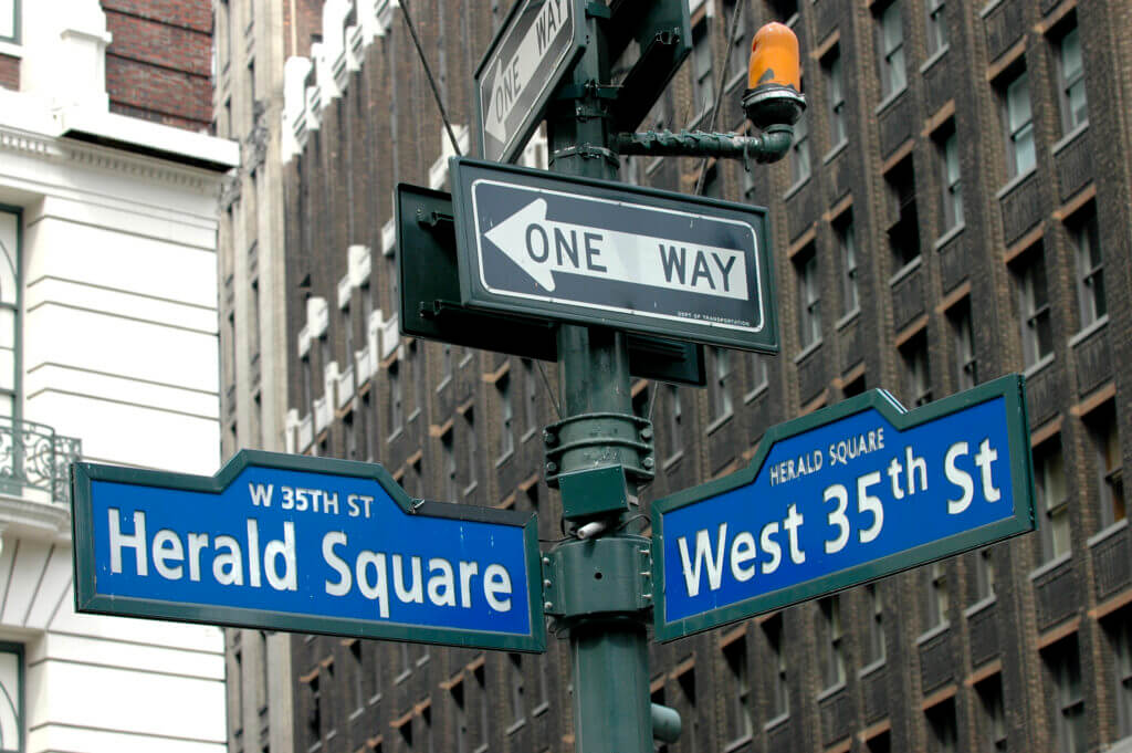 Street signs on the corner of Herald Square and West 35th Street in New York City.