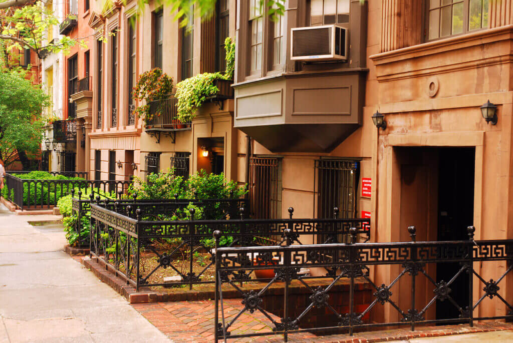 Elegant brownstones in Gramercy Park, Manhattan, showcasing varied styles and restorations.
