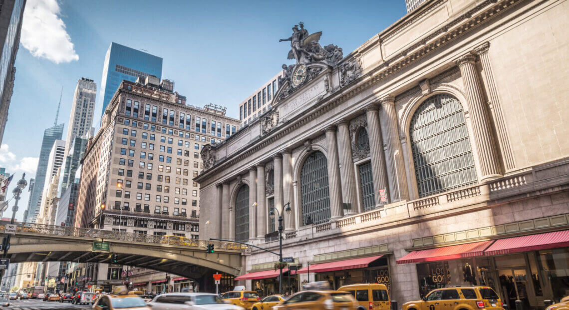 A photo of Grand Central Terminal in New York City, USA, with traffic in the foreground.