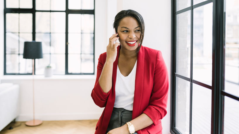 Black businesswoman making a phone call in a loft office space